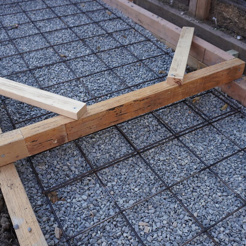 7mm square reo mesh panel installed vertically in a garden bed, supporting climbing plants in a modern backyard.