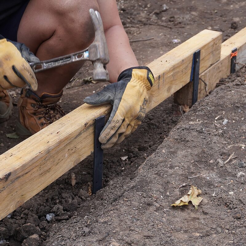 Durable 300mm metal formwork stake used to secure timber edging or support structures in garden construction.